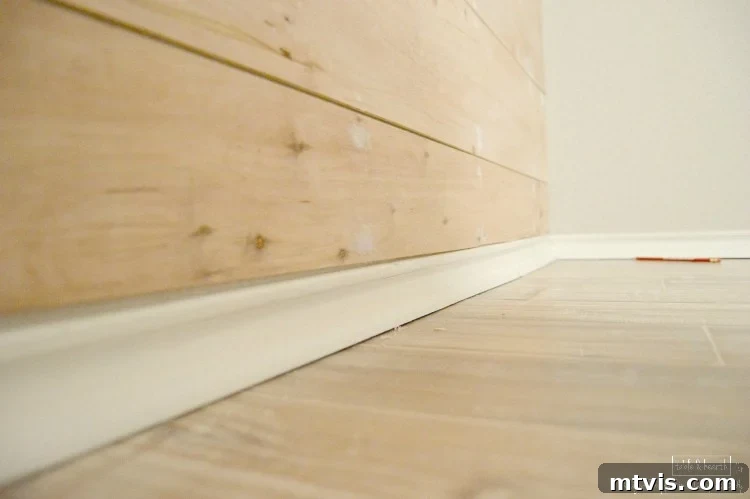 Build a Beautiful Wood Plank Accent Wall 6 Detailed shot of installed wood planks with visible gaps for a rustic look