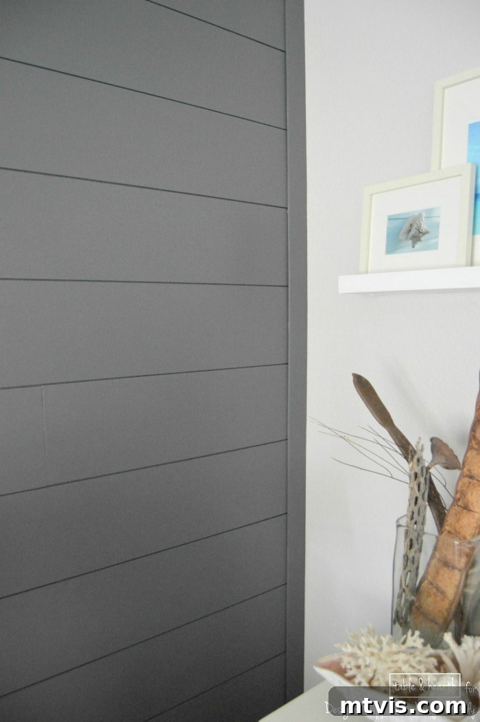 Build a Beautiful Wood Plank Accent Wall 10 Full view of the completed DIY wood plank wall in a serene guest room