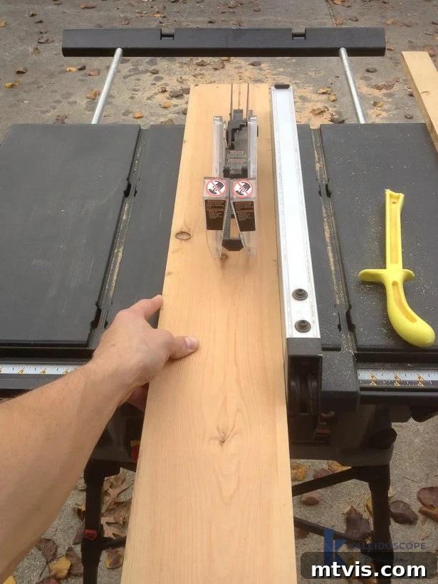 Close-up of a table saw ripping a pine board to the correct width for floating shelf support pieces, demonstrating precision cutting.