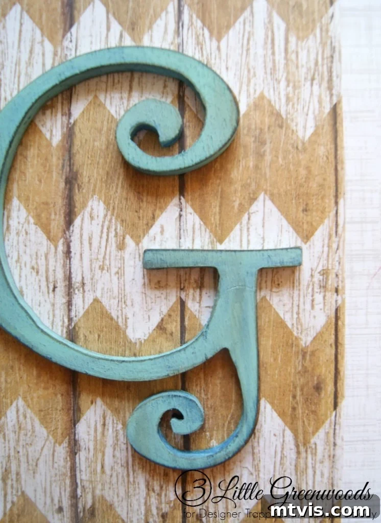 Adding unique flair: Scrapbook paper and a personalized monogram elevate the decorative box.