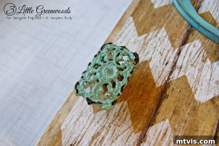 The final details: Attaching the homemade knob and personalized monogram for a polished finish.