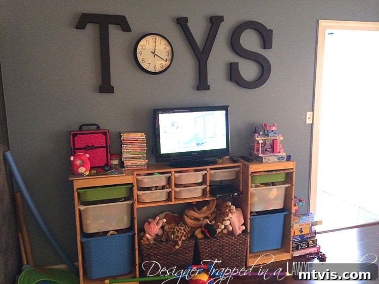 Industrial Chic: DIY Pipe Shelves and Integrated Workspaces 3 Before photo of a cluttered playroom floor with puzzles stacked and toys overflowing, highlighting the need for better organization.