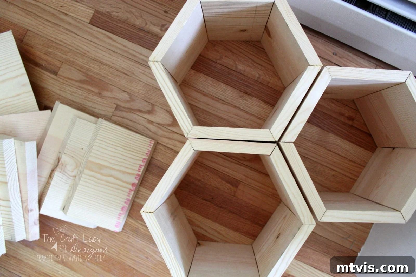 Honeycomb Shoe Organizer 11 An overhead view of assembled hexagonal shoe cubbies put together with nails and wood glue. Additional raw wood pieces are to the left.