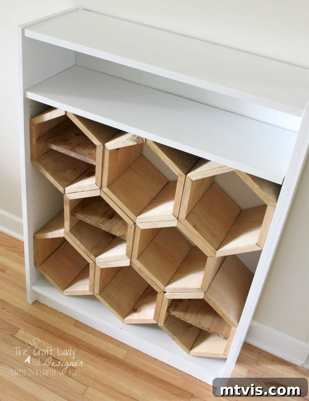 Honeycomb Shoe Organizer 17 A white bookshelf with custom honeycomb-style wooden hexagon shoe compartments fitted inside the lower half, with a short white shelf above for additional storage.