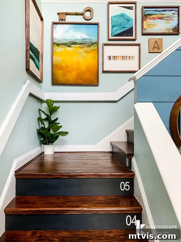 Transforming Carpeted Stairs To DIY Hardwood 11 Colorful gallery wall with various sized frames above newly installed DIY hardwood stairs, adding personality to the entryway