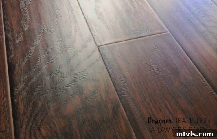 How Laminate Flooring Transformed Our Living Space 3 Close-up of beautiful hand-scraped laminate flooring, showcasing its realistic texture and aesthetic appeal.