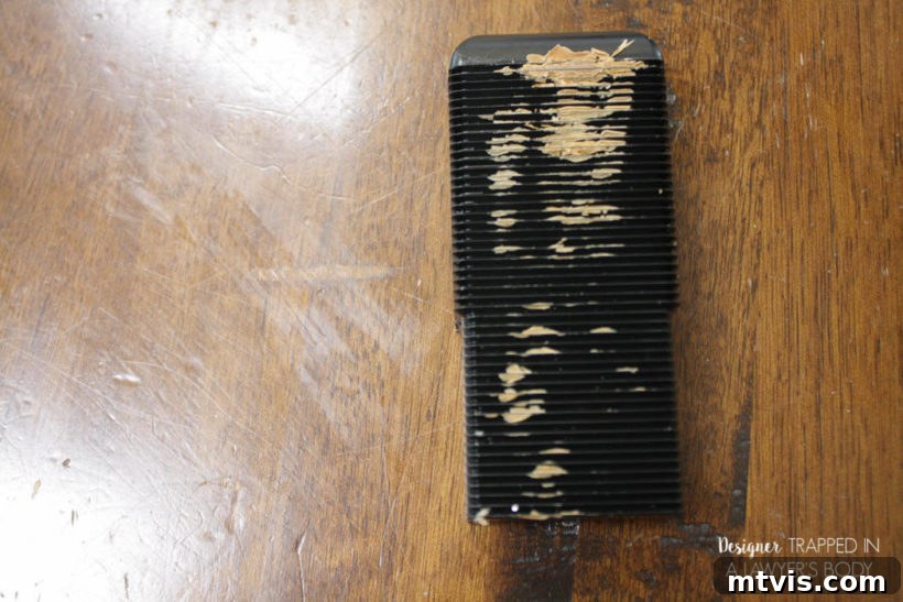 Easy Table Makeover: No Sanding, No Stripping 12 Leveling tool being used to smooth filled gouges on a table