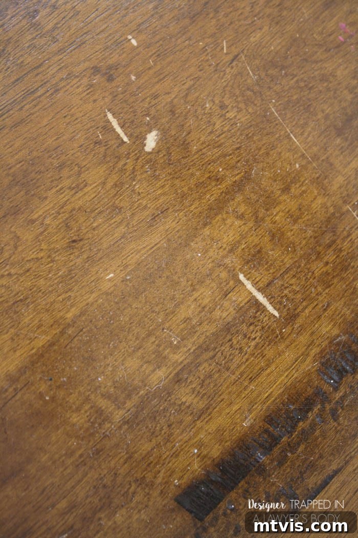 Easy Table Makeover: No Sanding, No Stripping 4 Close-up of scratched wood tabletop before refinishing