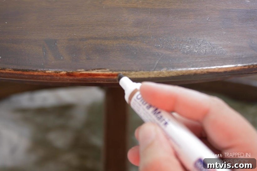 Easy Table Makeover: No Sanding, No Stripping 10 Applying furniture marker to restore a worn table edge