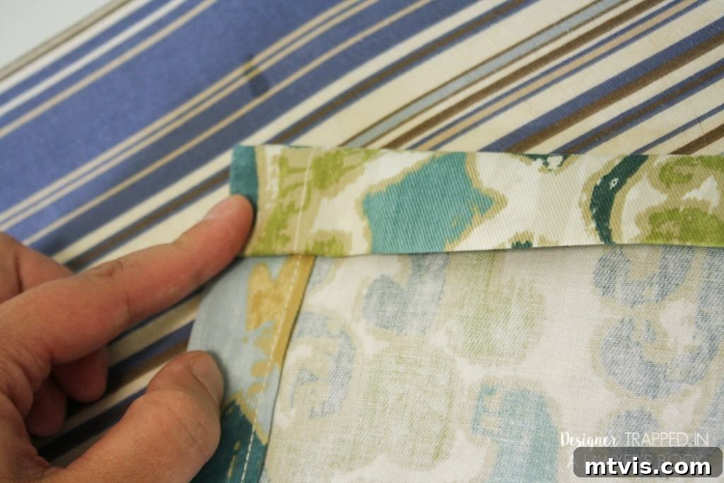 Repeating the hemming process for the top and bottom edges of your DIY curtain panel.