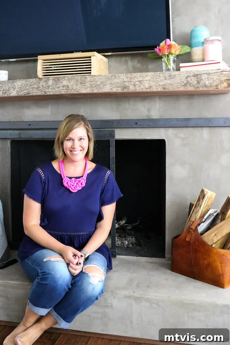 Stylish Concrete Fireplace Build for Under 100 12 A modern DIY concrete fireplace featuring a stylish metal sliding barn door screen, adding both functionality and a contemporary design element.
