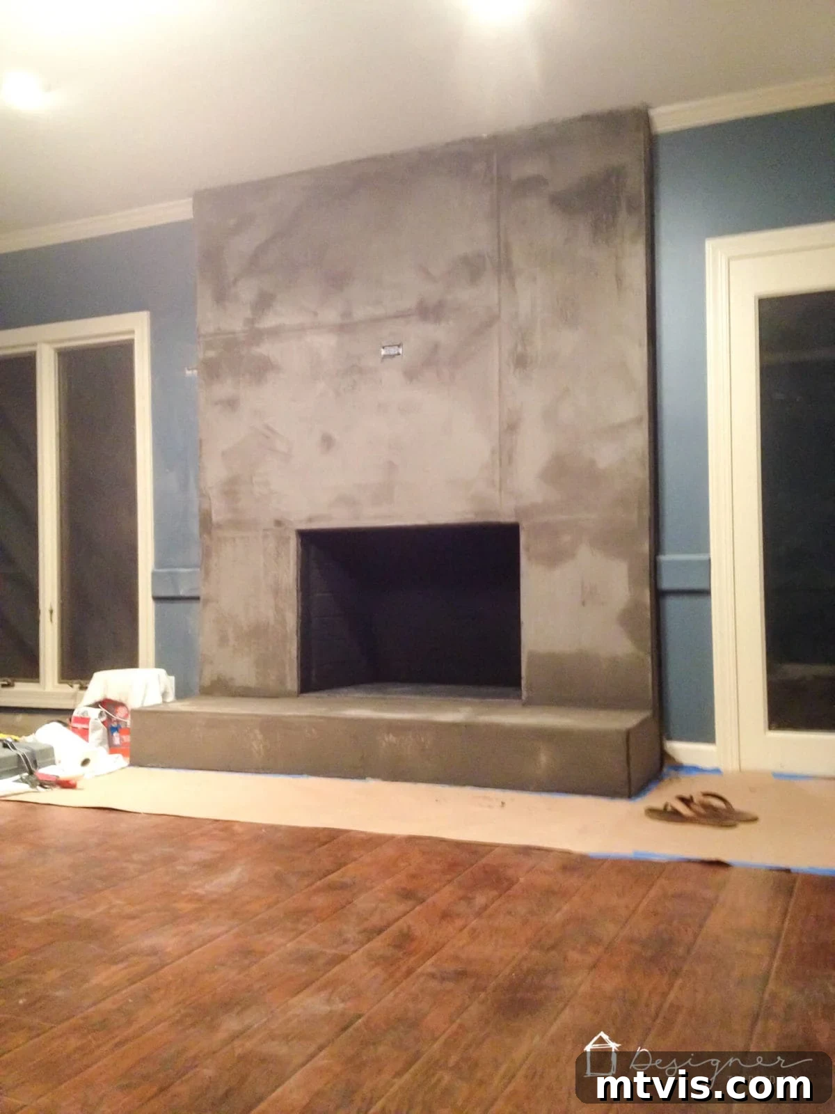 Stylish Concrete Fireplace Build for Under 100 8 The fireplace after the first thin coat of concrete, showing some visible cement board seams as it begins to dry, a normal stage in the DIY process.