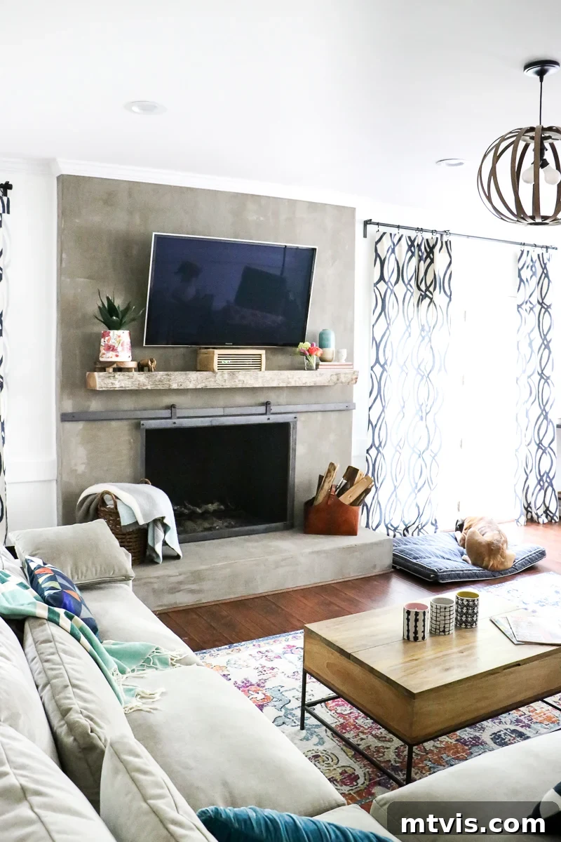 Stylish Concrete Fireplace Build for Under 100 10 A vibrant family room featuring a striking DIY concrete fireplace, adorned with colorful decor and modern furnishings.