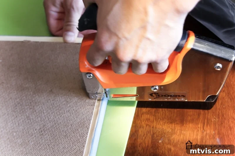 Craft Stunning Frames No Workshop Needed 7 Stapling artwork into the back of a DIY picture frame