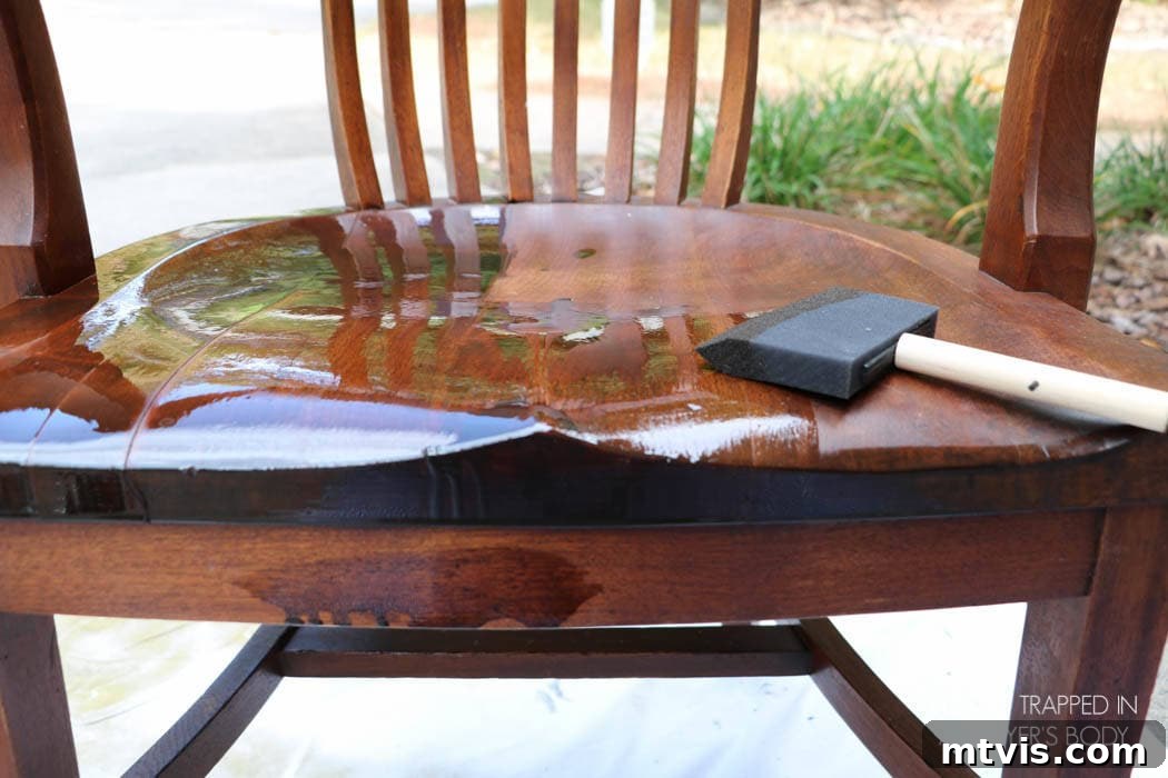 Effortless Wood Chair Refinishing 11 Wiping away excess Mohawk Wiping Wood Stain to achieve a desired finish on the wood chair, showing the easy application.
