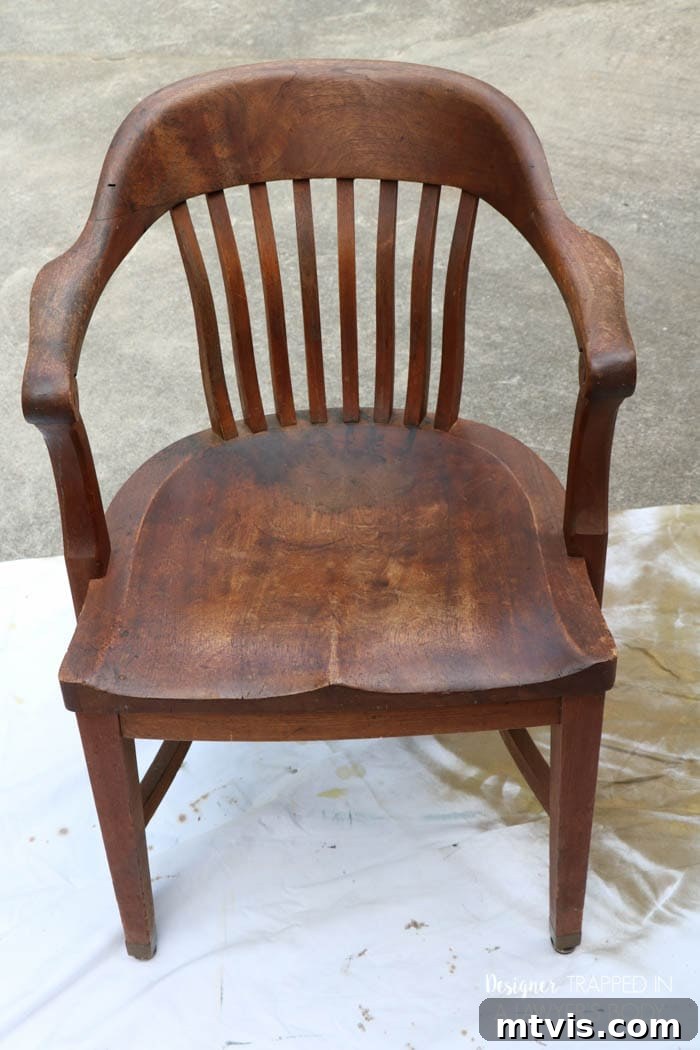 Effortless Wood Chair Refinishing 3 Before refinishing: a wooden banker's chair seat with noticeable stains and color variations. Learn how to easily fix these imperfections.