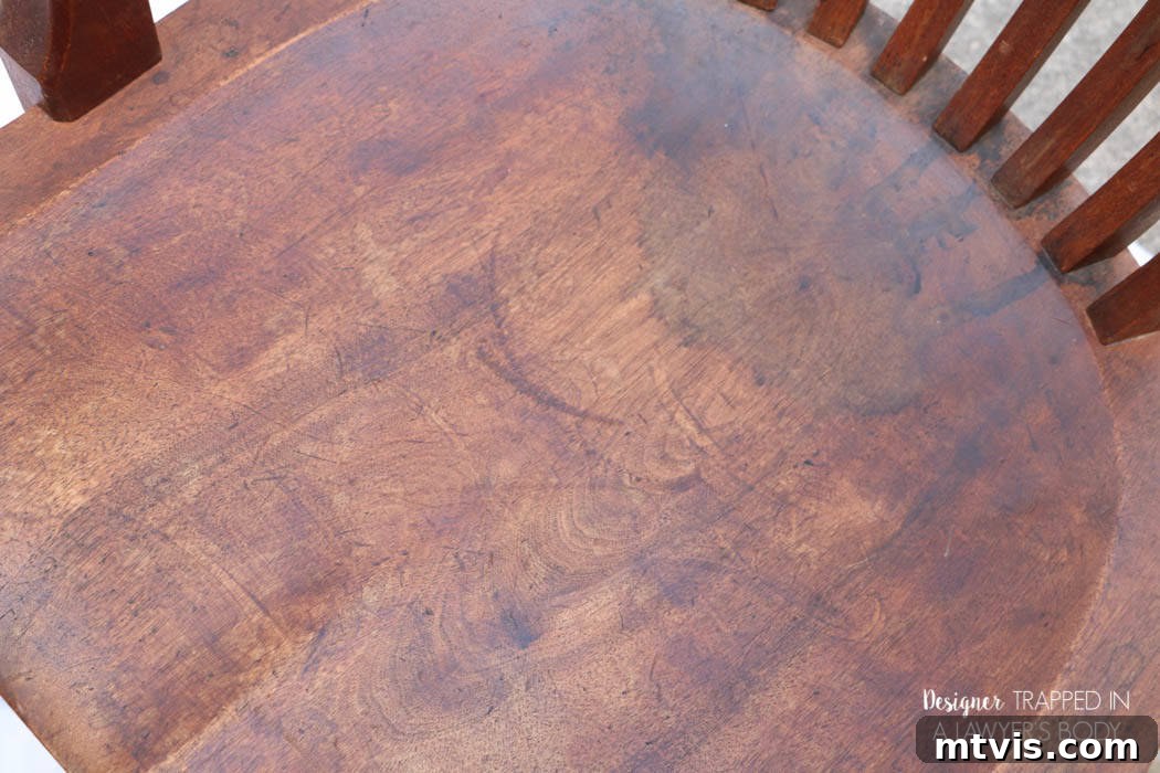 Effortless Wood Chair Refinishing 4 Detailed view of the first antique wood chair before restoration, showing widespread wear and original finish degradation.