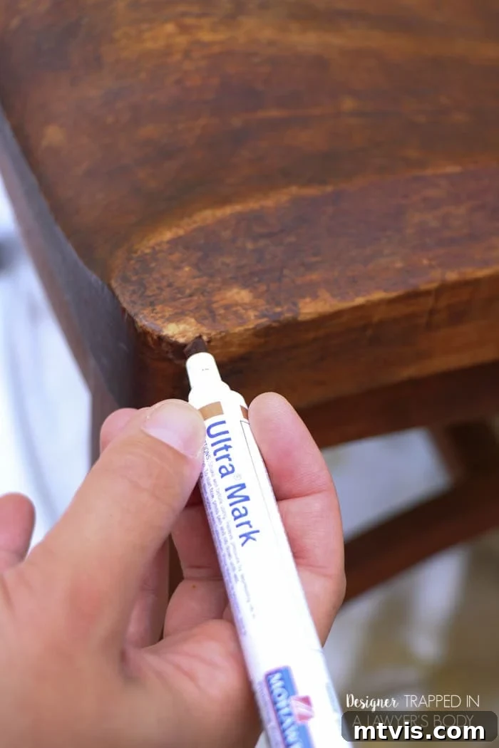 Effortless Wood Chair Refinishing 8 Using a Mohawk Ultra Touch-Up Marker to repair worn edges on a wood chair, a quick and effective refinishing step.