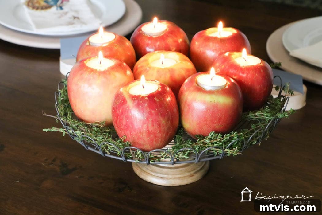 Crafting Homemade Apple Candles 6 Fresh apples turned into elegant tealight candle holders, surrounded by fragrant herbs in a stunning table centerpiece