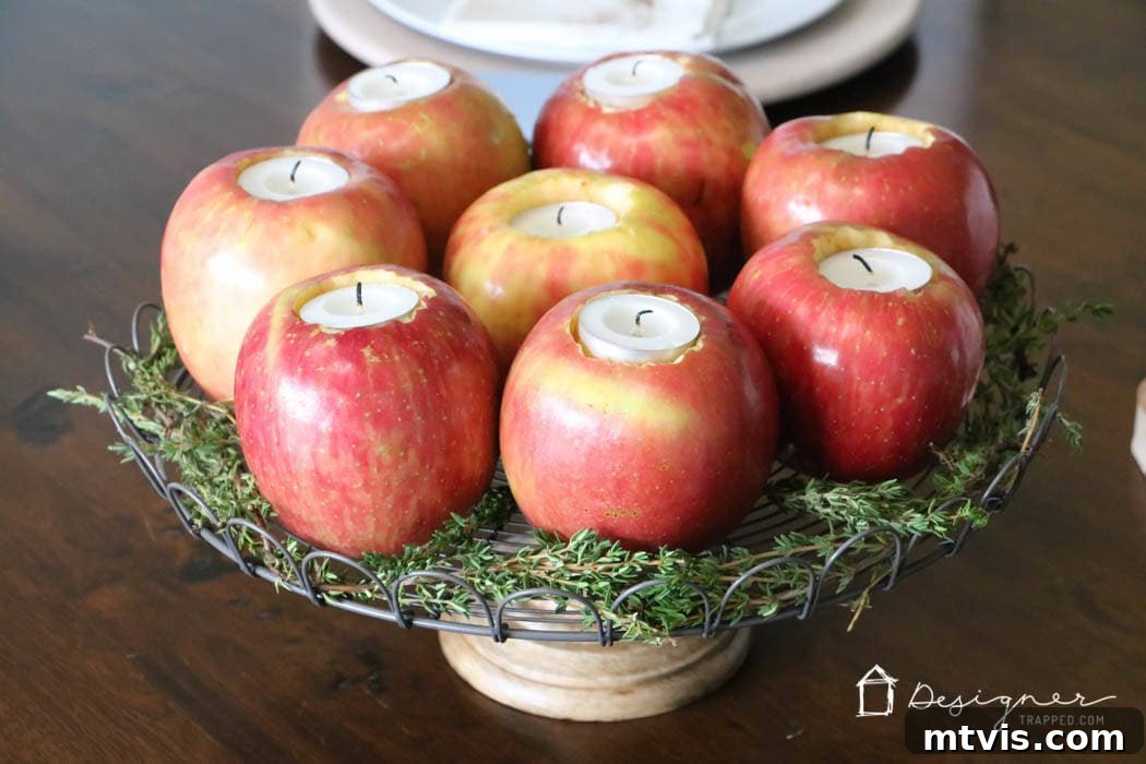 Crafting Homemade Apple Candles 8 Close-up of a festive table centerpiece with fresh herbs beautifully surrounding apple tealight candle holders
